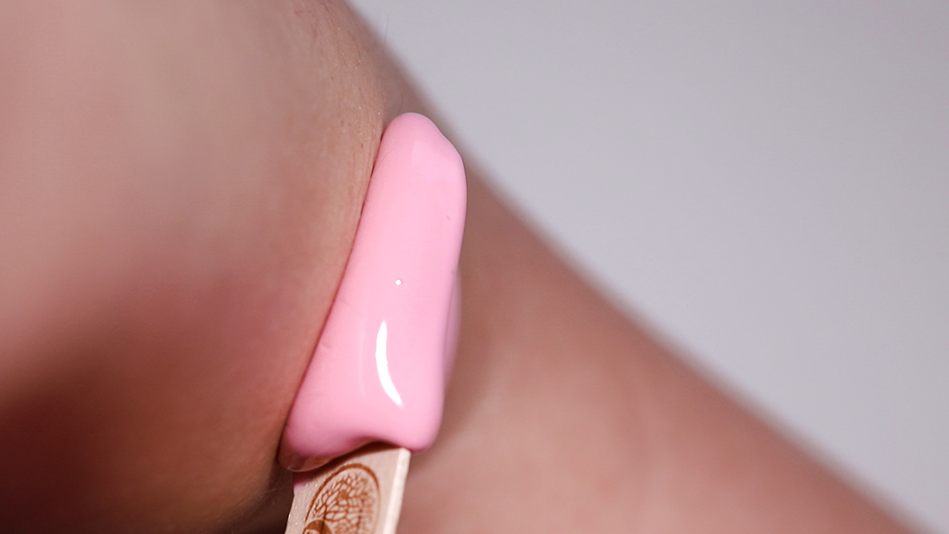 A small dab of pink Plumeria wax on smooth, calm skin